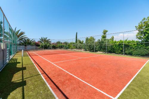 a tennis court with a net on top of it at Villa Amelia by Ezoria Villas in Perivolia
