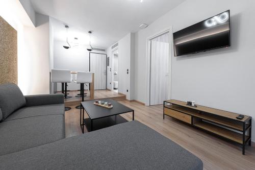 a living room with a couch and a table at Ethereal Athεns in Athens