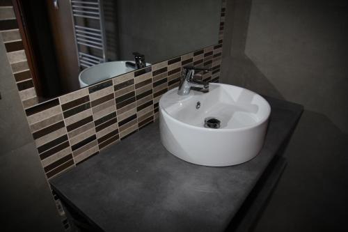a bathroom with a white sink and a mirror at Casa Genes Chera in Chera