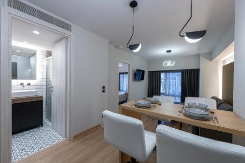 a kitchen and dining room with a table and chairs at Ethereal Athεns in Athens