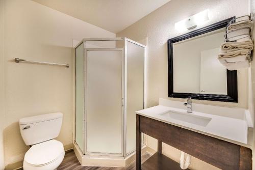 a bathroom with a shower and a toilet and a sink at Econo Lodge Stockton near I-5 Fairgrounds in Stockton