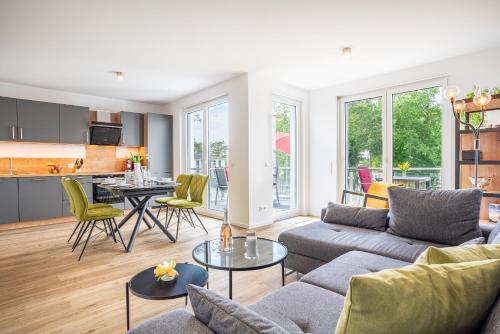 a living room with a couch and a table at Apartment "Marco Polo" - Haffresidenz in Garz-Usedom