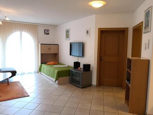 a bedroom with a bed and a television in it at Al Ponte 4 in Leukerbad