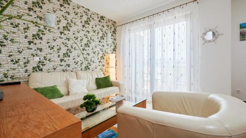 a living room with a couch and a table at Apartment Clementin in Slatine