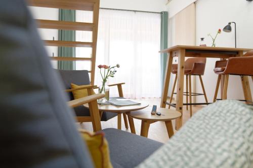 a living room with a table and chairs at Alpin Chalet Trinkl - adults only ab 16 Jahren in Bad Wiessee
