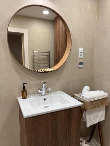 a bathroom with a sink and a mirror at Marių Banga in Nida