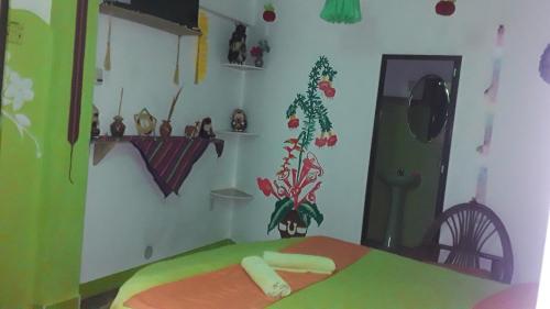a room with a bed in a room with decorations on the wall at Hostal Piedra Andina in Copacabana