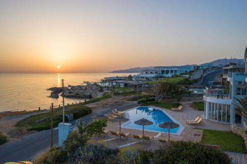 a view of a resort with a pool and the ocean at Romantica Beach in Hersonissos