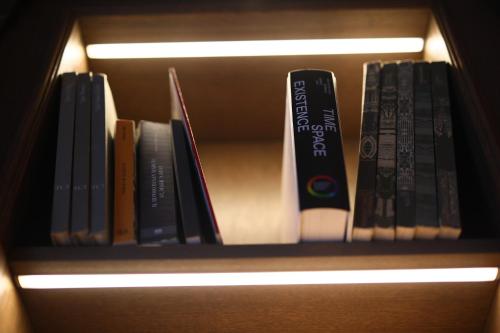 a book shelf filled with books in a cabinet at Santa Croce Boutique Hotel in Venice