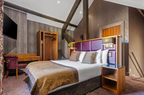 a hotel room with a bed and a desk at Roomzzz Newcastle City in Newcastle upon Tyne
