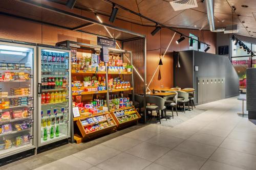 a store with a lot of food and drinks at Roomzzz Newcastle City in Newcastle upon Tyne