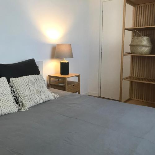 a bedroom with a bed and a table with a lamp at THE RANCH Apartment 4 Capalbio in Pescia Romana