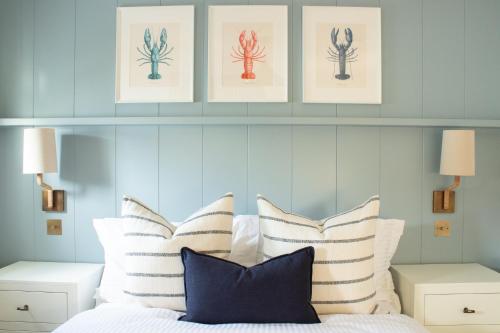 a bedroom with a bed with striped pillows at Richardson Apartment in Aberaeron