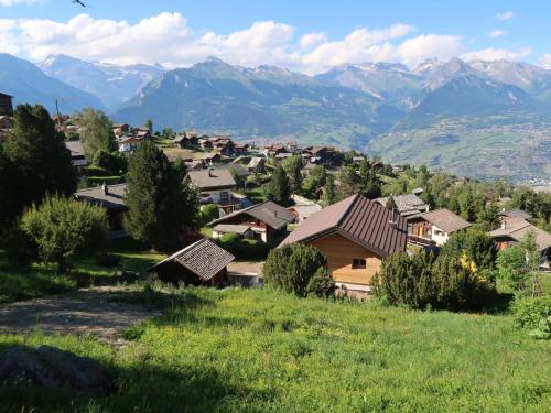 a small village with mountains in the background at Chalet Mungg by Interhome in Nendaz
