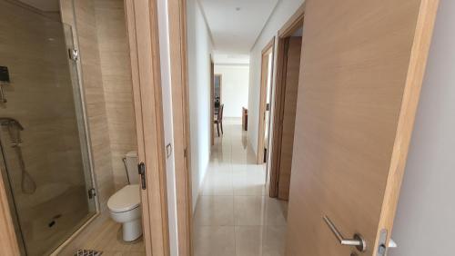 a bathroom with a toilet and a walk in shower at Plage des nation Prestigia 2 bedroom 100 mètre to the beach with huge pool 