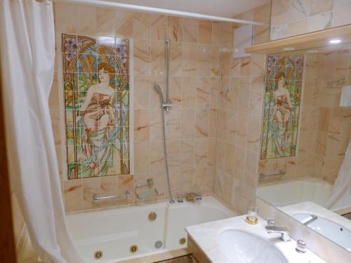 a bathroom with a tub and a sink and a shower at Apartment Terrasse Des Alpes 708 by Interhome in Vermala