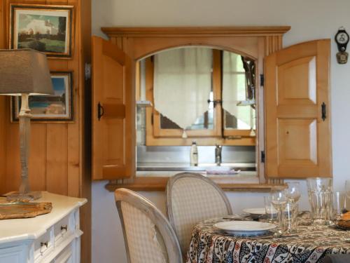 a dining room with a table and chairs and a kitchen at Apartment Argentière 3 by Interhome in Villars-sur-Ollon