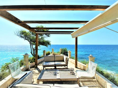 a patio with chairs and the ocean in the background at Holiday Home Casa Taty by Interhome in Villajoyosa