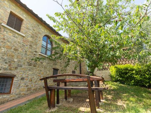 a wooden bench sitting in front of a building at Apartment Ciliegio by Interhome in Monsanto
