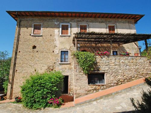 an old stone building with flowers on it at Apartment Ciliegio by Interhome in Monsanto