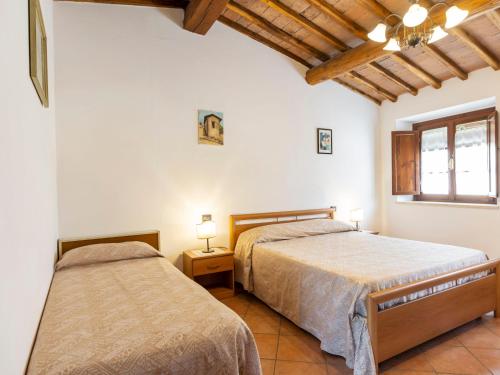 a bedroom with two beds and a window at Apartment Ciliegio by Interhome in Monsanto