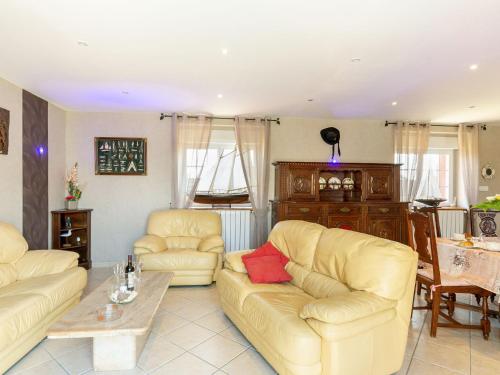 a living room with two couches and a table at Holiday Home Villa Mor-Eol - PNR211 by Interhome in Plounéour-Trez