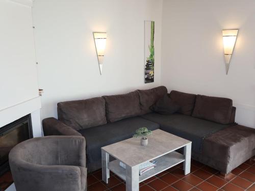 a living room with a couch and a coffee table at Holiday Home Mee - hrzeit - HOK106 by Interhome in Hooksiel