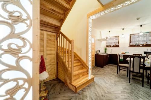 a room with a staircase and a dining room at Komfortowe domki na wynajem - Holiday Tatry in Poronin