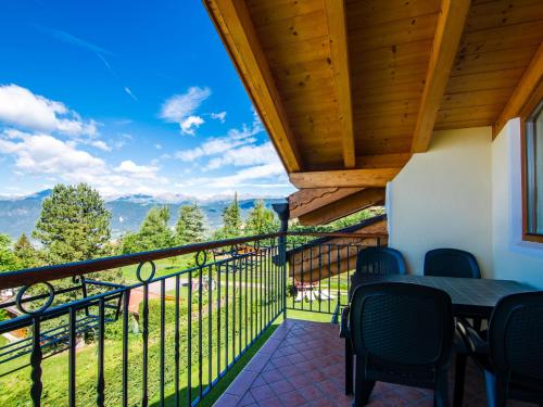 a balcony with a table and chairs and a view at Apartment Pensione Villa Belfiore-1 by Interhome in Ronzone
