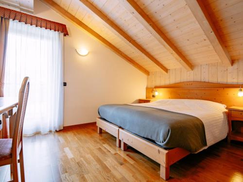 sypialnia z dużym łóżkiem i stołem w obiekcie Apartment Pensione Villa Belfiore-1 by Interhome w mieście Ronzone