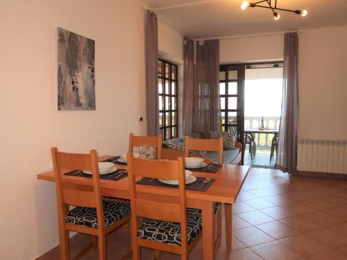 a dining room and living room with a table and chairs at Apartment Ulika by Interhome in Ravni