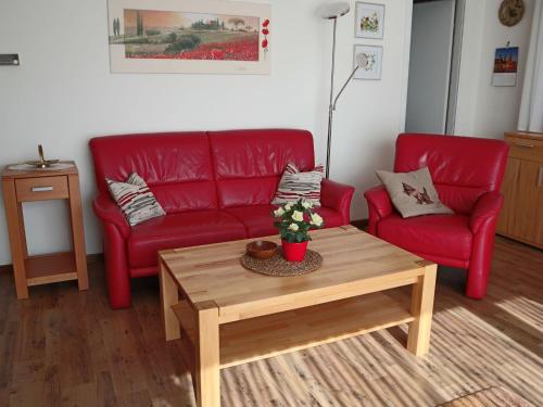 a living room with a red couch and a coffee table at Holiday Home Mily by Interhome in Dittishausen
