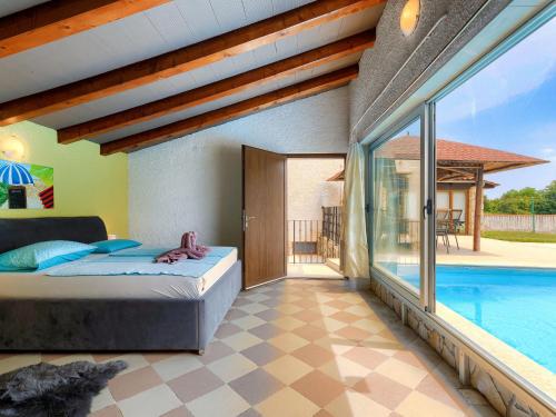 a bedroom with a bed and a swimming pool at Holiday Home Jadranka by Interhome in Muntić