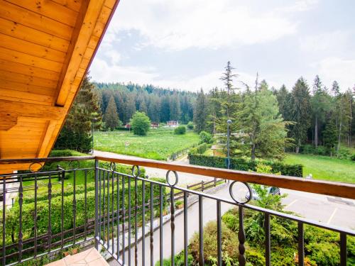 a balcony with a view of a field and trees at Apartment Pensione Villa Belfiore-2 by Interhome in Ronzone