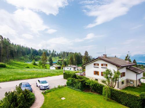 an aerial view of a house with two cars parked in a driveway at Apartment Pensione Villa Belfiore-2 by Interhome in Ronzone