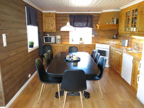 a dining room with a table and chairs in a kitchen at Holiday Home Utsikten - SOW134 by Interhome in Tjaldal