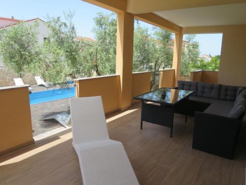 a living room with a couch and a table and chairs at Holiday Home Tina - BIG120 by Interhome in Biograd na Moru