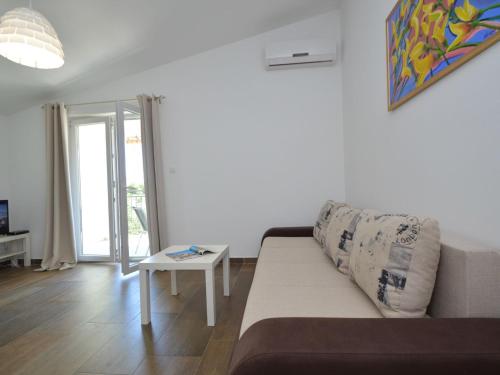 ein Wohnzimmer mit einem Sofa und einem Tisch in der Unterkunft Apartment Ivka-3 by Interhome in Tribunj