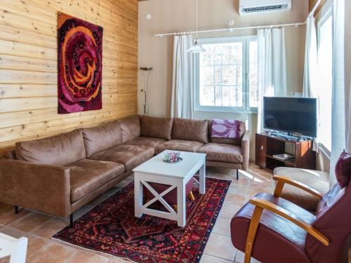 a living room with a couch and a table at Holiday Home Ylläskankare by Interhome in Äkäslompolo