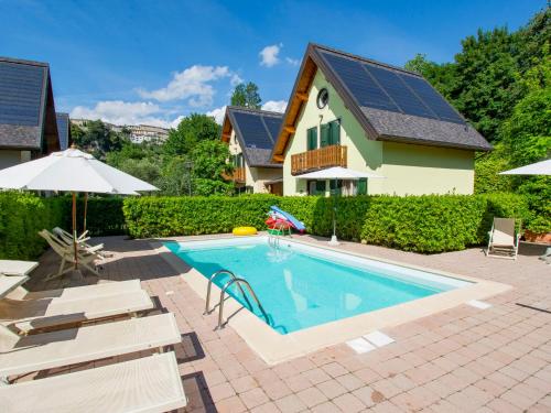 a house with a swimming pool with solar panels on the roof at Holiday Home Viola - BLU601 by Interhome in Coreglia Antelminelli