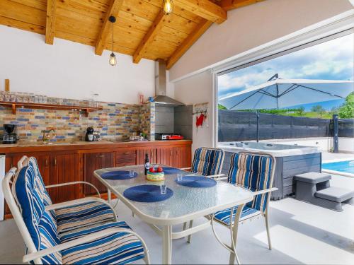 a kitchen with a table and chairs in a kitchen at Holiday Home Susanne by Interhome in Gorica