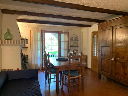 a dining room with a wooden table and chairs at Apartment Casa delle Palme by Interhome in Marina Romea