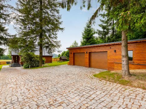 a house with a brick driveway and a garage at Chalet Jeschkenpanorama by Interhome in Kurort Oybin