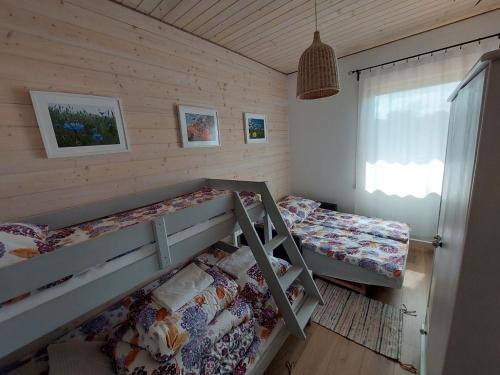 a bedroom with two bunk beds and a window at Siedlisko Upałty in Giżycko