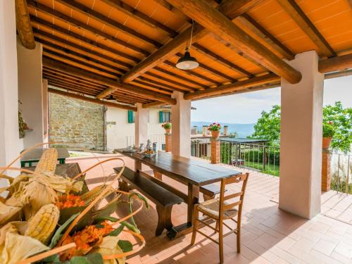 a patio with a wooden pergola and a wooden table at Holiday Home Appartamento Grande by Interhome in Reggello