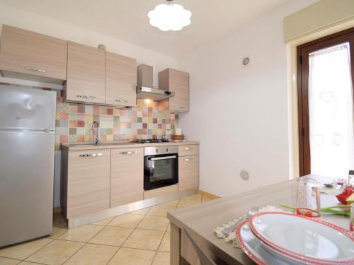 a kitchen with a refrigerator and a stove top oven at Apartment Zagara SinAgo by Interhome in Lascari