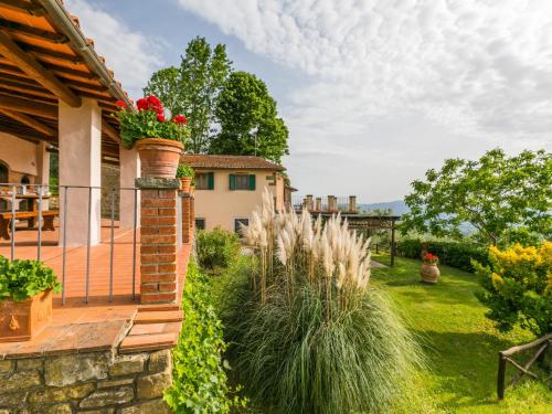 a house with a patio and a yard with plants at Holiday Home Podere Berrettino by Interhome in Reggello