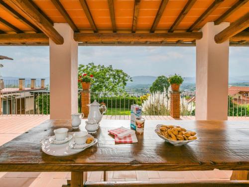 a wooden table with a bowl of food on it at Holiday Home Podere Berrettino by Interhome in Reggello