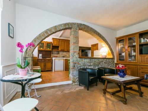 a living room with a stone archway and tables and chairs at Holiday Home Appartamento Piccolo by Interhome in Reggello