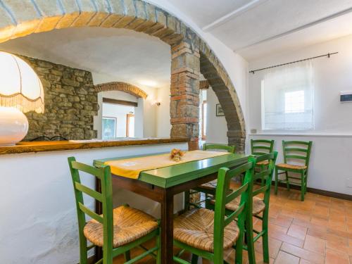 a dining room with a green table and chairs at Holiday Home Appartamento Piccolo by Interhome in Reggello